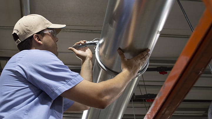 Man installing Nordfab Quick-Fit clamp together ducting